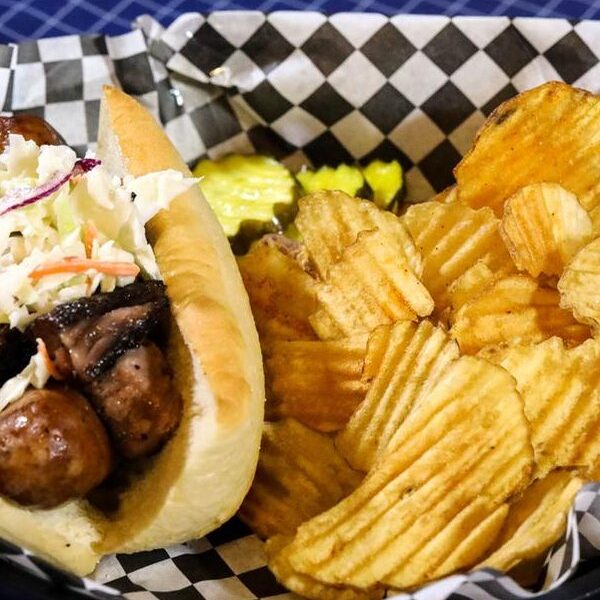 A Dixie Dog with brisket and slaw served with house-fried chips